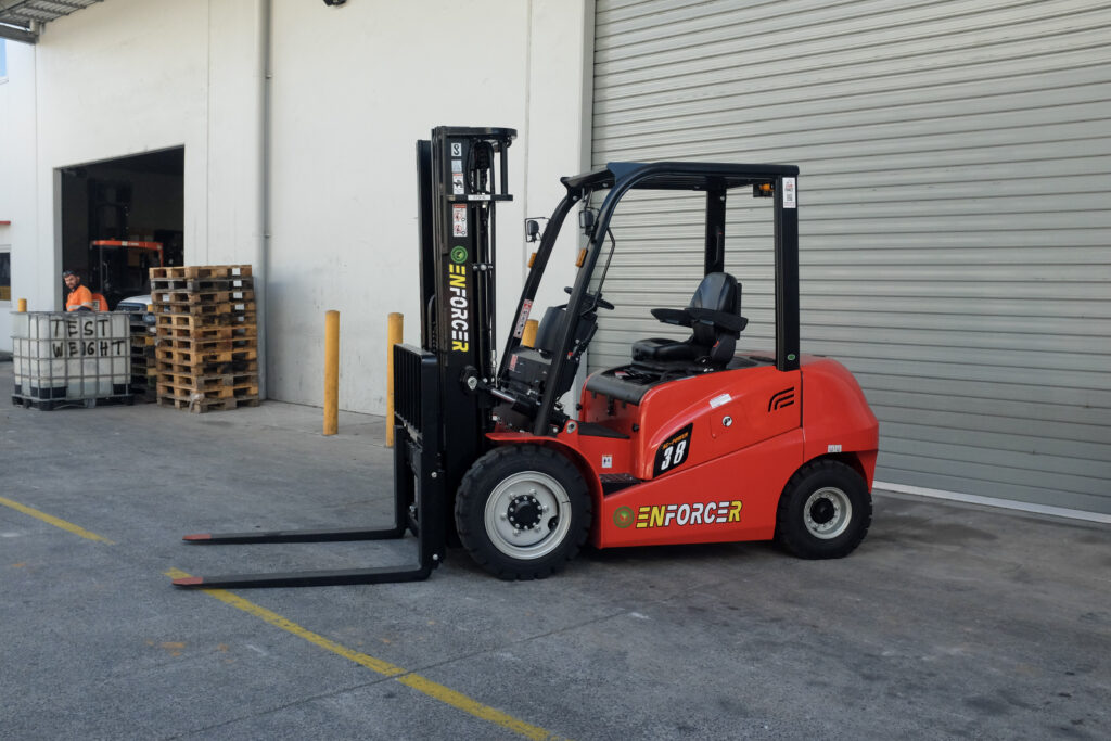 Enforcer Lithium Forklift in front of warehouse