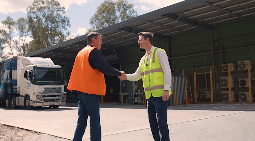 Workers handling forklifts with safety gear, representing premier forklift providers in Australia.